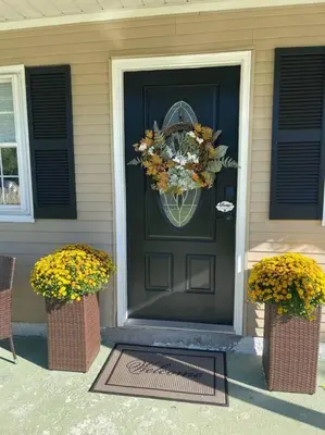 a black door with a wreath on it on a house at Rocky river Escape in Cleveland