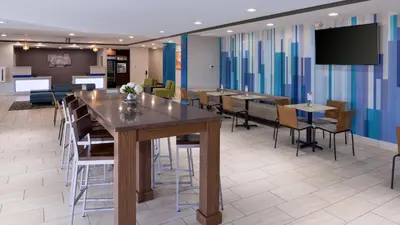 a conference room with a large table and chairs at Holiday Inn Express & Suites Lexington Midtown - I-75 by IHG in Lexington