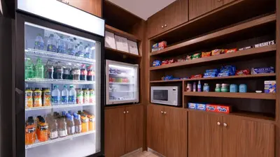a refrigerator filled with lots of bottles of drinks at Holiday Inn Express & Suites Lexington Midtown - I-75 by IHG in Lexington