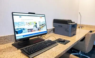a computer monitor and a printer on a desk at Holiday Inn Express & Suites New Martinsville by IHG in New Martinsville