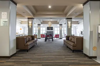 a lobby with couches and a table in a building at Holiday Inn Express & Suites New Martinsville by IHG in New Martinsville