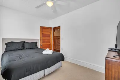 a bedroom with a bed and a ceiling fan at Cozy Renovated 19th Century Home, 5 Min to OSU! in Columbus