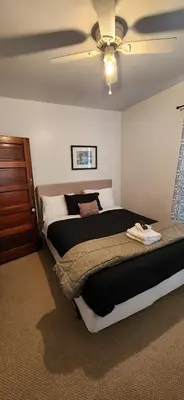 a bedroom with two beds and a ceiling fan at Cozy Renovated 19th Century Home, 5 Min to OSU! in Columbus
