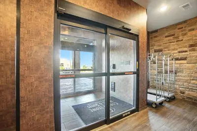 a room with a window with a view of a city at Cobblestone Hotel & Suites - Bellefontaine in Bellefontaine