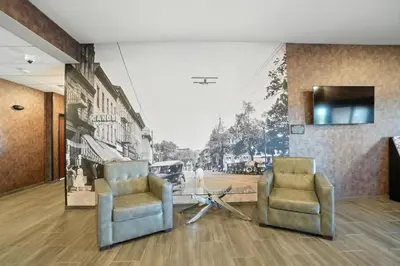 two chairs in a room with a wall mural at Cobblestone Hotel & Suites - Bellefontaine in Bellefontaine