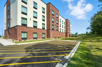 an empty street in front of a brick building at Cobblestone Hotel & Suites - Bellefontaine in Bellefontaine