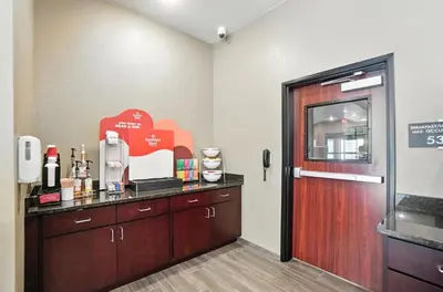 a hotel room with a counter and a door at Cobblestone Hotel & Suites - Bellefontaine in Bellefontaine