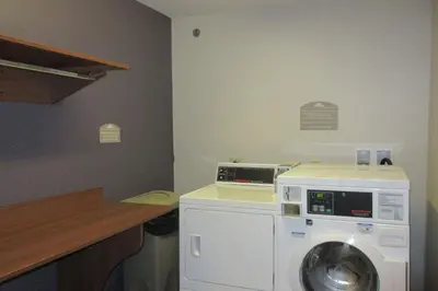 a laundry room with a washing machine and a counter at Quality Inn & Suites Caldwell I-77 in Caldwell
