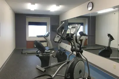 a gym with two tread machines and a mirror at Quality Inn & Suites Caldwell I-77 in Caldwell