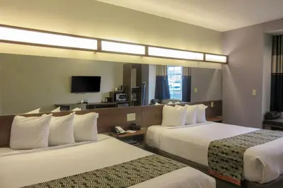 a hotel room with two beds and a television at Quality Inn & Suites Caldwell I-77 in Caldwell