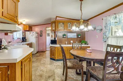 a kitchen with a table and a dining room at Paden City Home Near Ohio River! in New Martinsville