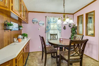 a kitchen and dining room with a table and chairs at Paden City Home Near Ohio River! in New Martinsville