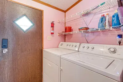 a washer and dryer in a pink laundry room at Paden City Home Near Ohio River! in New Martinsville