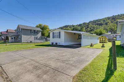 a driveway in a residential neighborhood with houses at Paden City Home Near Ohio River! in New Martinsville