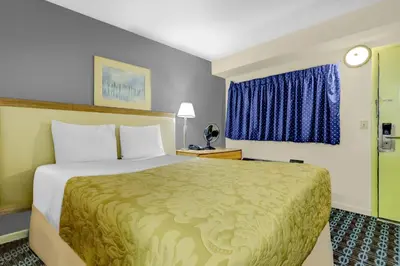 a hotel room with a bed and a window at Brookville Inn By OYO Near Dayton International Airport in Brookville