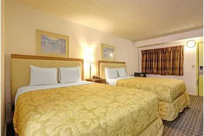a hotel room with two beds in a room at Brookville Inn By OYO Near Dayton International Airport in Brookville