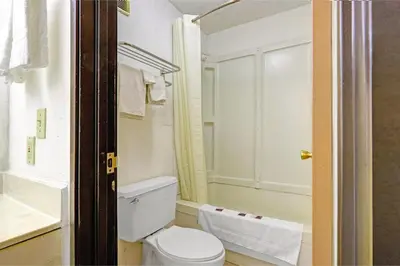 a bathroom with a toilet and a shower at Brookville Inn By OYO Near Dayton International Airport in Brookville