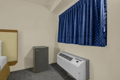 a room with a air conditioner and a window at Brookville Inn By OYO Near Dayton International Airport in Brookville