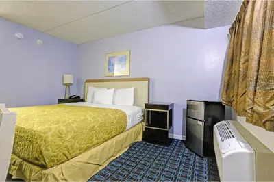 a hotel room with a bed and a bathroom at Brookville Inn By OYO Near Dayton International Airport in Brookville