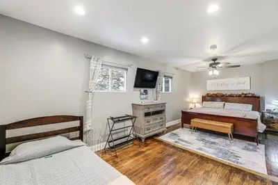 a bedroom with two beds and a television in it at half Mi to Creation Museum Home with Large Yard! in Petersburg