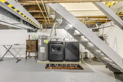 a laundry room with a washing machine and a staircase at half Mi to Creation Museum Home with Large Yard! in Petersburg