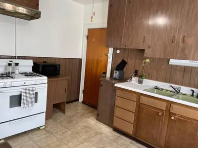 a kitchen with a white stove and a sink at First Floor Room 8 min from Cle Airport Quiet Street All you need in 1st District Police Station Heliport