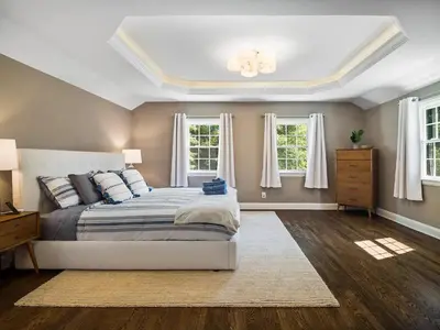 a bedroom with a bed and two windows at Shaker Prestige - 4 000 sq ft - Calm and Quiet in Shaker Heights