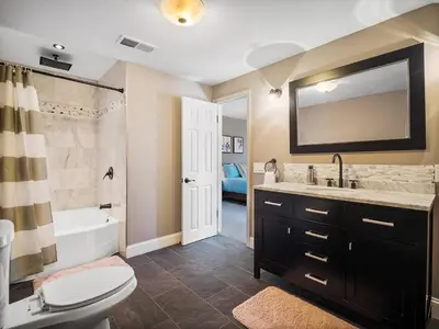a bathroom with a toilet and a sink and a tub at Shaker Prestige - 4 000 sq ft - Calm and Quiet in Shaker Heights