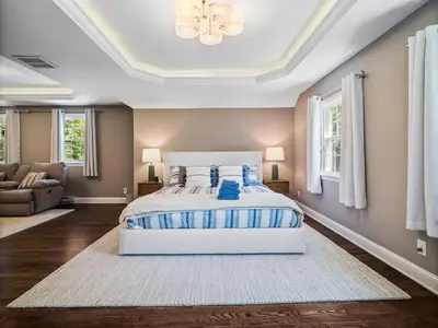a bedroom with a large bed with blue pillows at Shaker Prestige - 4 000 sq ft - Calm and Quiet in Shaker Heights