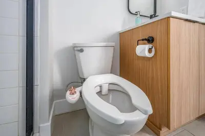 a bathroom with a white toilet in a room at Prime OTR, 1 Block to TQL, Cali King Bed, Sleeps 4ppl, Free Light Rail, Smart TVs in Over-The-Rhine