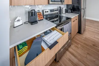a kitchen with a stove and a refrigerator at Prime OTR, 1 Block to TQL, Cali King Bed, Sleeps 4ppl, Free Light Rail, Smart TVs in Over-The-Rhine