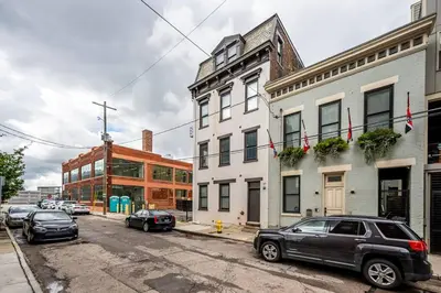 a city street with cars parked in front of buildings at Prime OTR, 1 Block to TQL, Cali King Bed, Sleeps 4ppl, Free Light Rail, Smart TVs in Over-The-Rhine