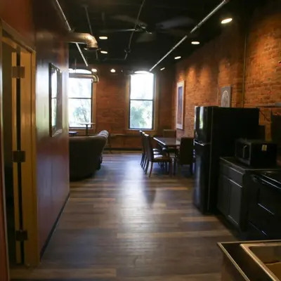 a room with a kitchen and a table and a refrigerator at Downtown Cleveland Historic District in Cleveland