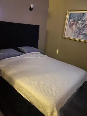 a bed in a bedroom with a picture on the wall at Downtown Cleveland Historic District in Cleveland