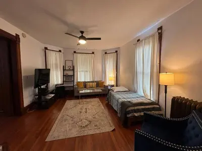 a living room with a bed and a couch at Eighty Three-Historic Downtown in Chillicothe