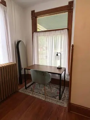 a desk in a room with a chair and a window at Eighty Three-Historic Downtown in Chillicothe