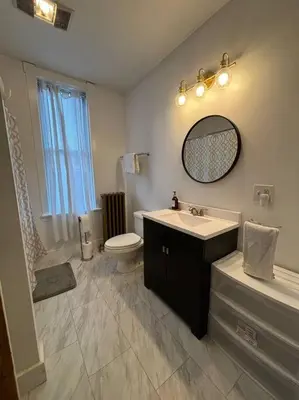 a bathroom with a sink and a toilet and a mirror at Eighty Three-Historic Downtown in Chillicothe