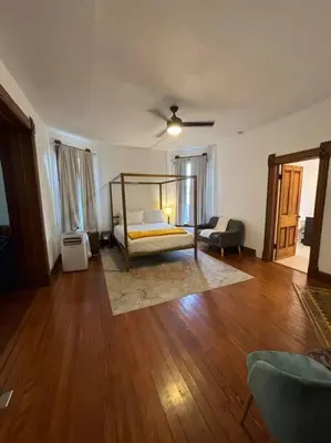 a bedroom with a bed and a wooden floor at Eighty Three-Historic Downtown in Chillicothe