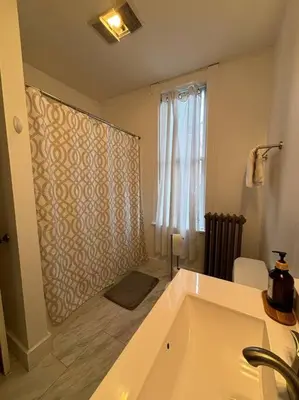 a bathroom with a bath tub and a window at Eighty Three-Historic Downtown in Chillicothe