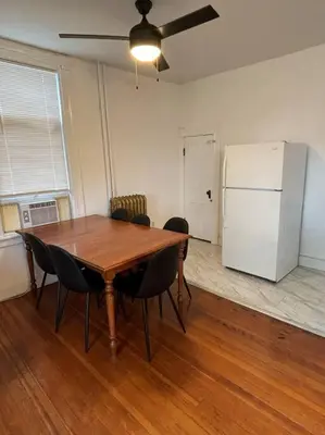 a dining room table with chairs and a refrigerator at Eighty Three-Historic Downtown in Chillicothe