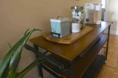 a wooden table with a coffee maker on it at The Loft Downtown in Chillicothe