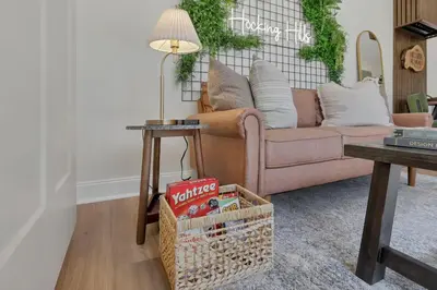 a living room with a couch and a table at The Hillside Retreat - Cozy container home with Hot tub and Fire pit in Logan