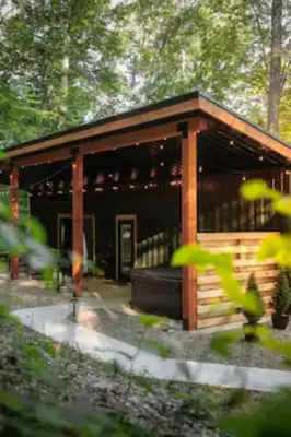 a small cabin in the middle of a forest at The Hillside Retreat - Cozy container home with Hot tub and Fire pit in Logan