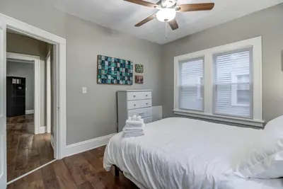 a bedroom with a bed and a ceiling fan at The Gallery House - Art curated by local artist! in Cleveland Heights
