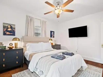 a bedroom with a bed and a ceiling fan at Classic Meets Contemporary I Minutes to Cle Clinic in Cleveland Heights