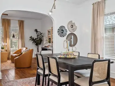 a dining room with a black table and chairs at Classic Meets Contemporary I Minutes to Cle Clinic in Cleveland Heights