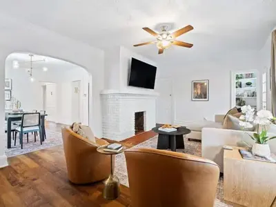 a living room with a couch and a ceiling fan at Classic Meets Contemporary I Minutes to Cle Clinic in Cleveland Heights