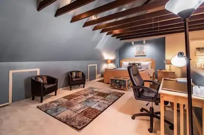 a room with a desk and chairs and a bedroom at Spacious Family Getaway - Near Cleveland Clinic in Cleveland