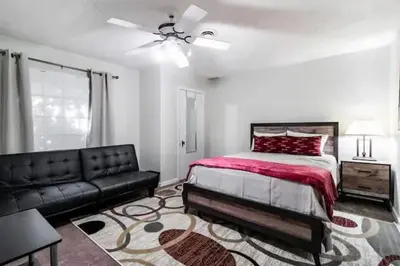 a bedroom with a bed and a couch at Spacious Family Getaway - Near Cleveland Clinic in Cleveland