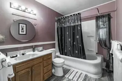 a bathroom with a tub and a toilet and a sink at Spacious Family Getaway - Near Cleveland Clinic in Cleveland